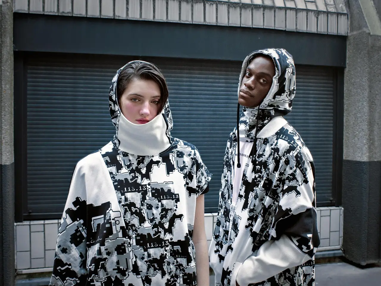 Adversarial Fashion Confronts Surveillance Norms